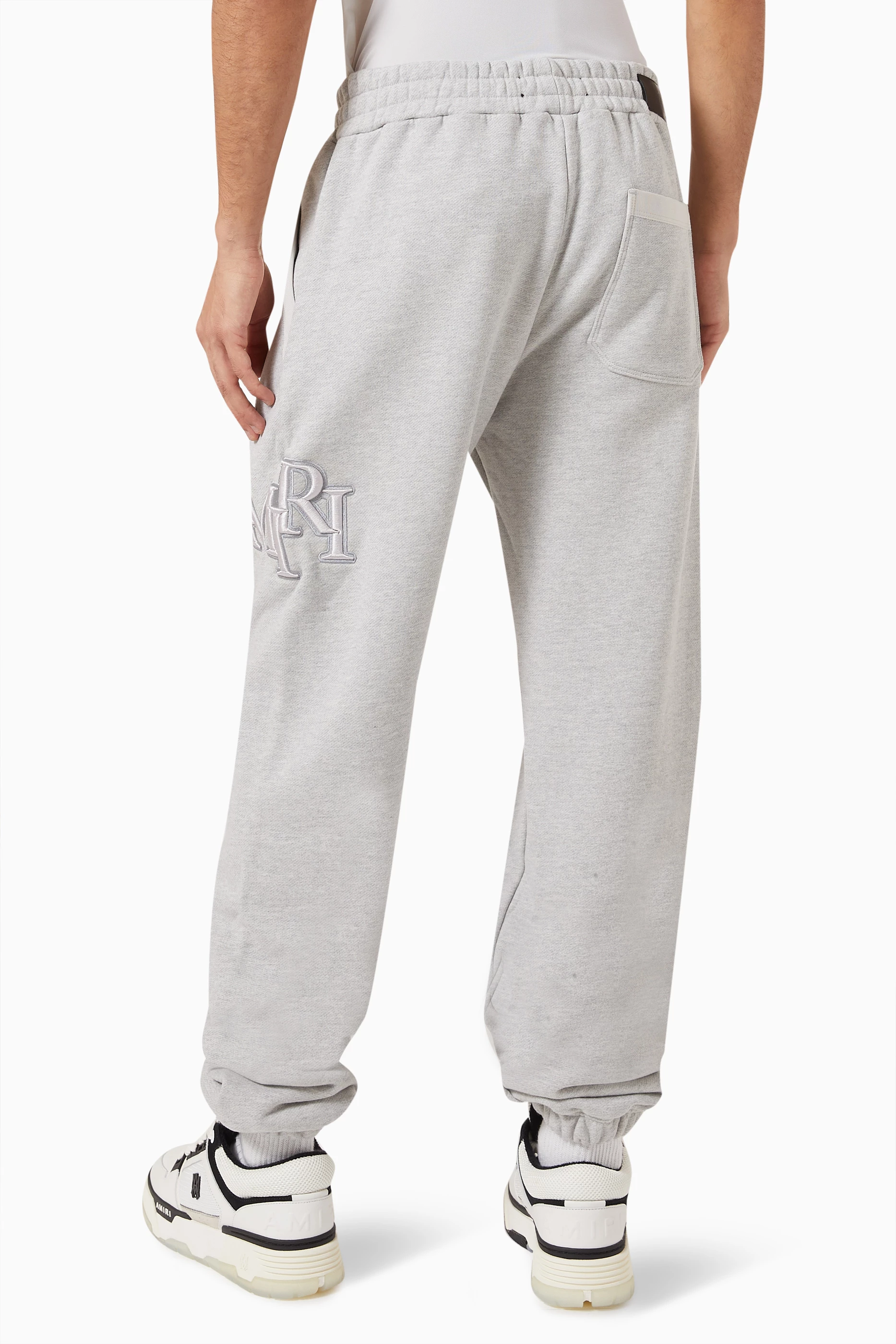 Buy Amiri Grey Staggered Logo Sweatpants in Cotton Terry for Men