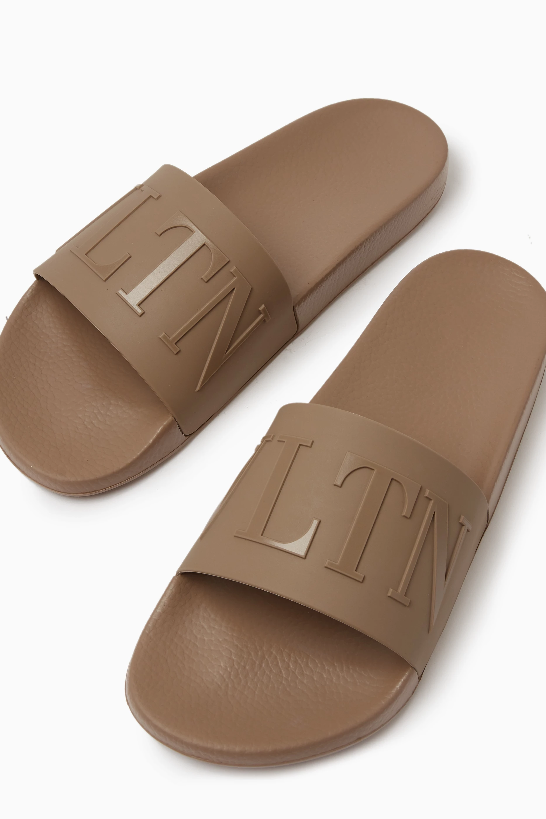 Buy Valentino Garavani Neutral Valentino Garavani VLTN Slide Sandals in Rubber For Men Online Ounass Saudi